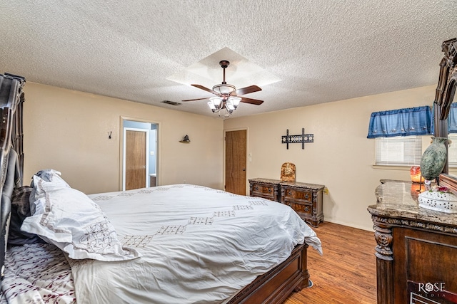 1729 Parkview Dr, San Angelo, TX 76904 - bedroom with light wood finished floors, a ceiling fan, and a textured ceiling