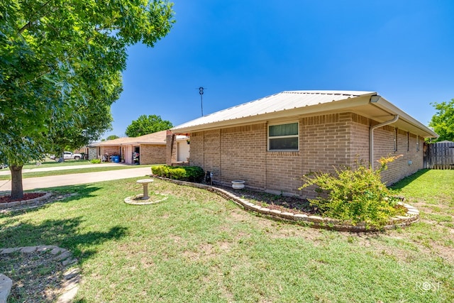 1729 Parkview Dr, San Angelo, TX 76904 - view of home's exterior with driveway, a garage, and brick siding