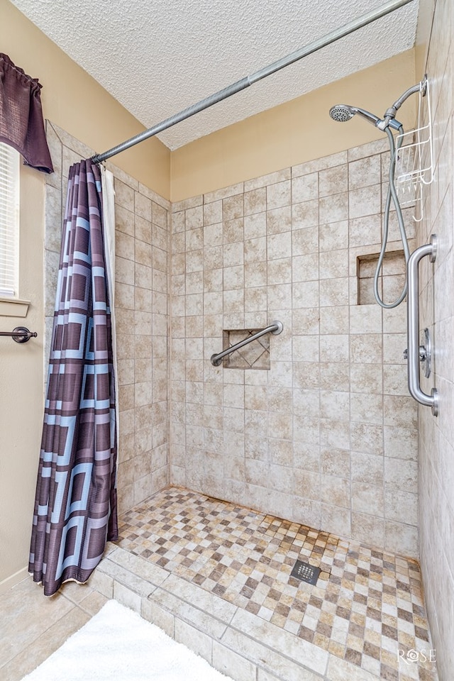 1729 Parkview Dr, San Angelo, TX 76904 - full bathroom with tiled shower and a textured ceiling