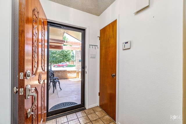 1729 Parkview Dr, San Angelo, TX 76904 - foyer featuring light tile patterned floors and a textured ceiling