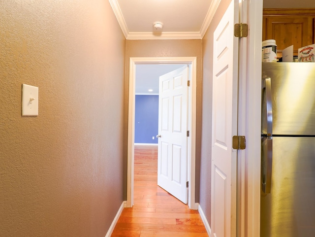 hall featuring crown molding and light wood-type flooring