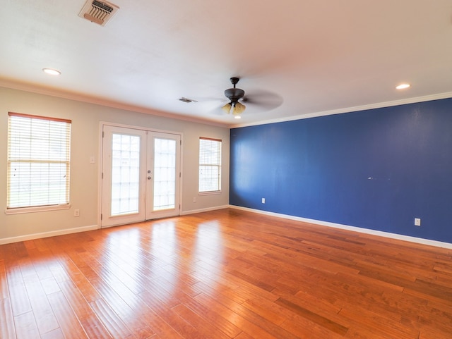 unfurnished room featuring hardwood / wood-style flooring and crown molding