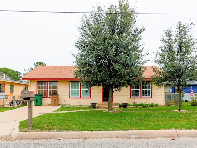 ranch-style home with a front lawn