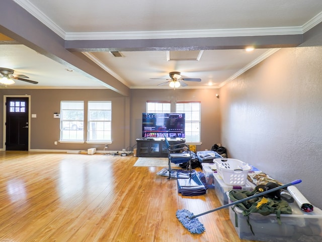 living room featuring wood-type flooring, ornamental molding, and ceiling fan