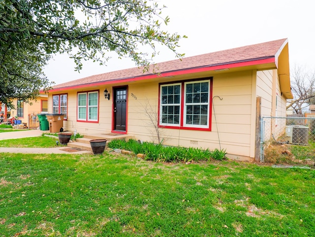 single story home with central AC unit and a front lawn