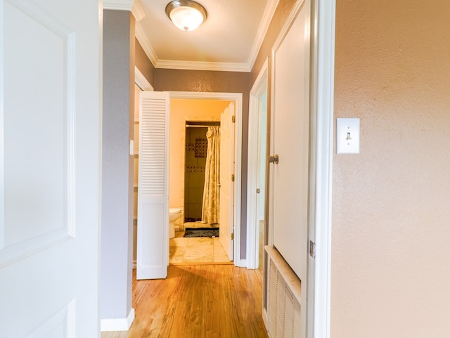 corridor featuring crown molding and light wood-type flooring