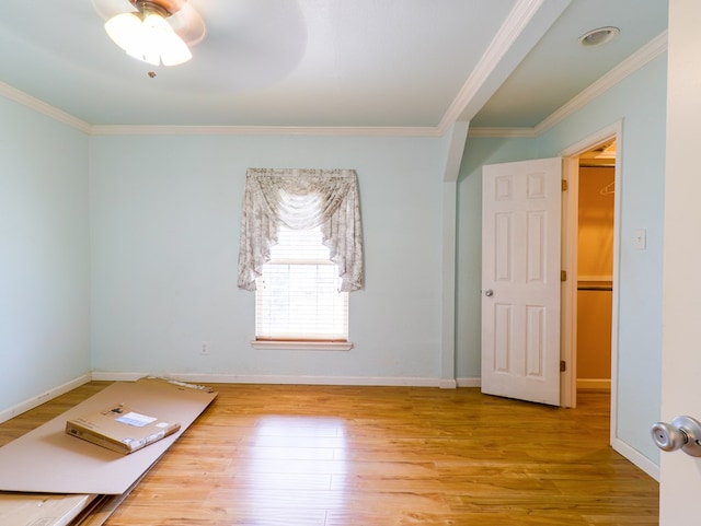 empty room with hardwood / wood-style floors and ornamental molding