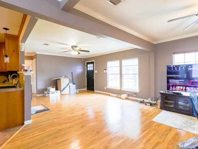 living room with crown molding, ceiling fan, sink, and light hardwood / wood-style floors