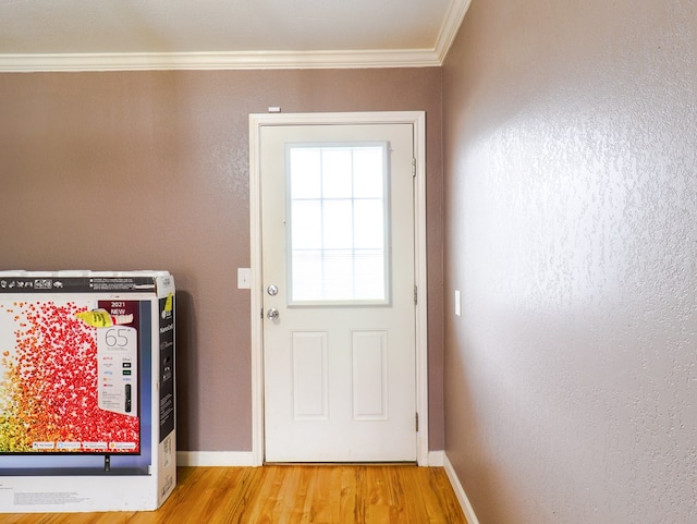 doorway to outside with hardwood / wood-style floors and ornamental molding