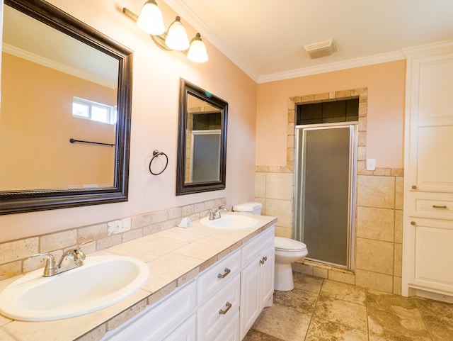 bathroom featuring ornamental molding, toilet, tile walls, and a shower with shower door