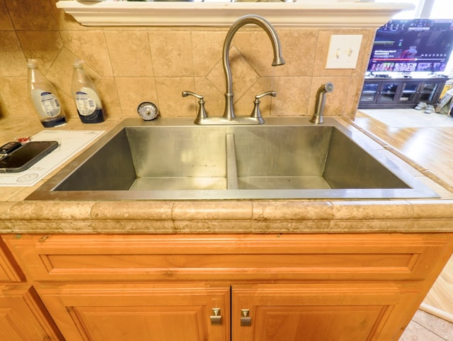 room details featuring sink and decorative backsplash