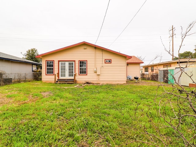 rear view of house with a yard