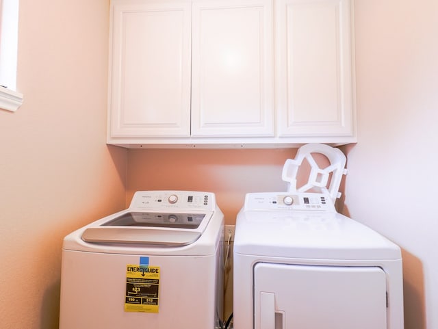 laundry room with cabinets and washer and dryer