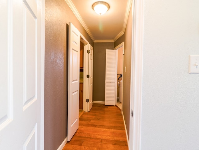 corridor featuring hardwood / wood-style flooring and ornamental molding