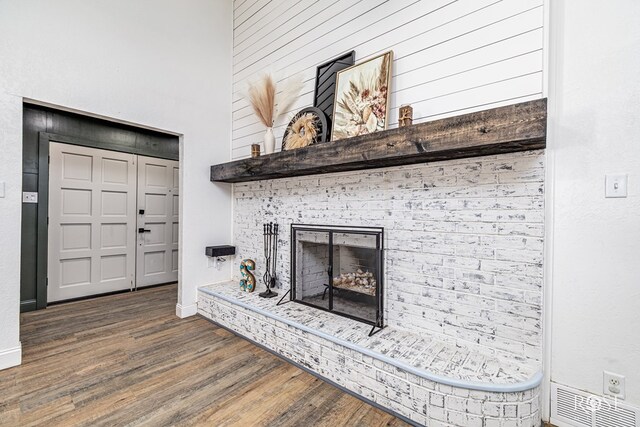 3610 Southland Blvd, San Angelo, TX 76904 - unfurnished living room with wood finished floors, baseboards, and a brick fireplace