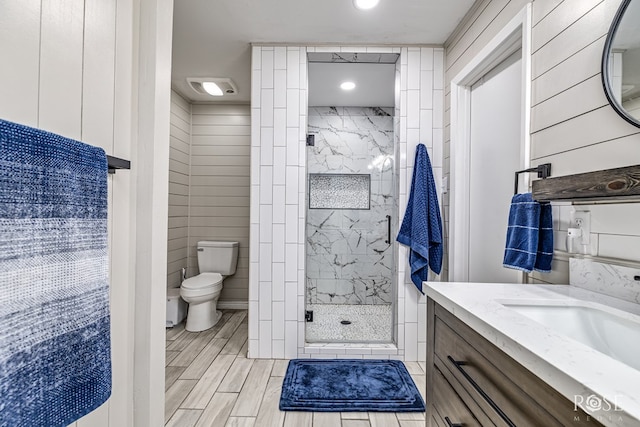 3610 Southland Blvd, San Angelo, TX 76904 - full bathroom with vanity, a marble finish shower, toilet, recessed lighting, and wood finished floors