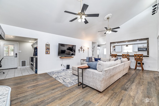 3610 Southland Blvd, San Angelo, TX 76904 - living area featuring a ceiling fan, wood finished floors, baseboards, and high vaulted ceiling