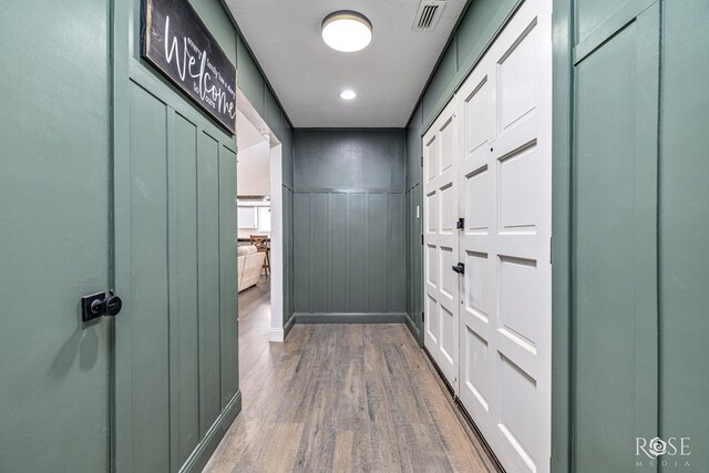 3610 Southland Blvd, San Angelo, TX 76904 - corridor with wood finished floors, a decorative wall, and wainscoting