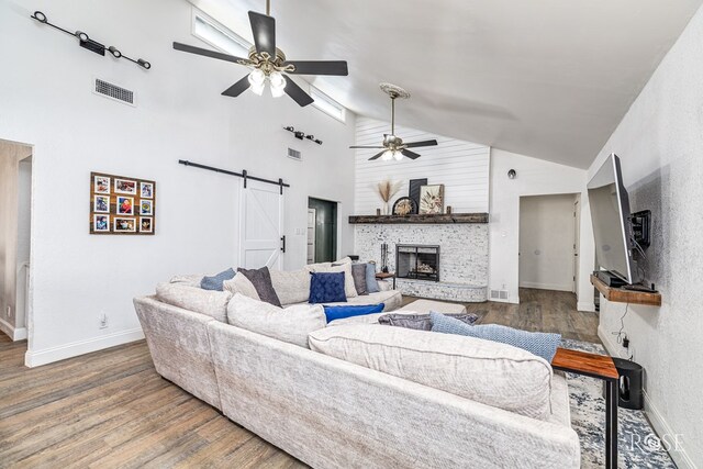 3610 Southland Blvd, San Angelo, TX 76904 - living room featuring a barn door, ceiling fan, high vaulted ceiling, wood finished floors, and baseboards