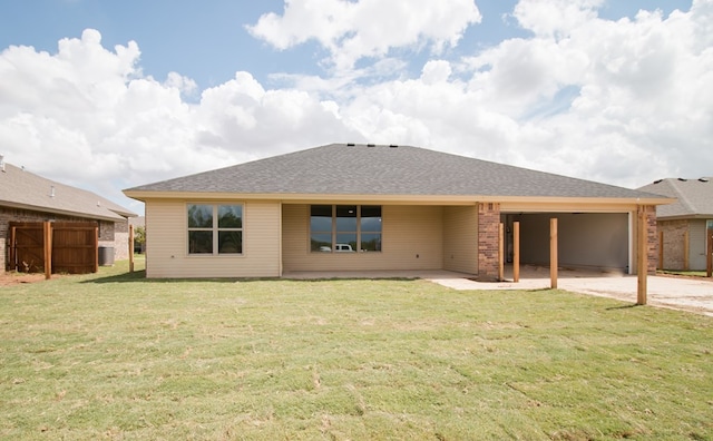 back of house with central AC and a lawn