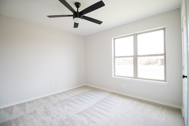 carpeted spare room with ceiling fan and a healthy amount of sunlight