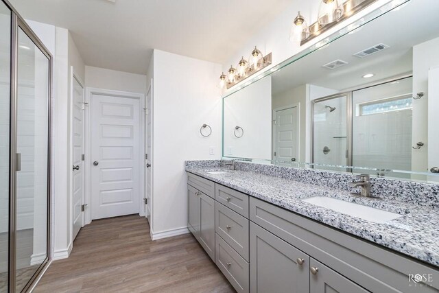 bathroom featuring vanity, hardwood / wood-style flooring, and walk in shower