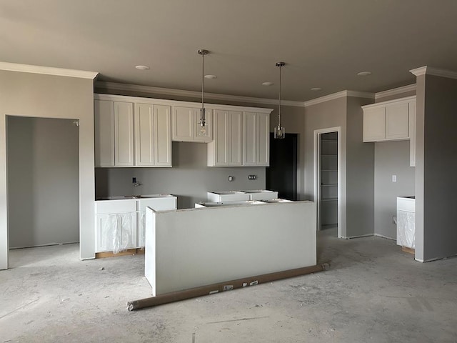 kitchen featuring pendant lighting, crown molding, a kitchen island, and white cabinets