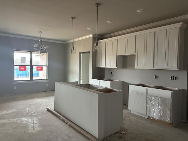 kitchen featuring white cabinetry, crown molding, and decorative light fixtures