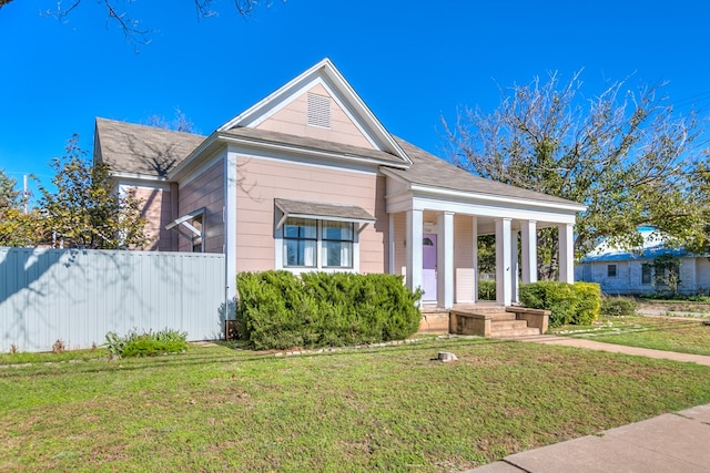 view of front of house featuring covered porch and a front lawn