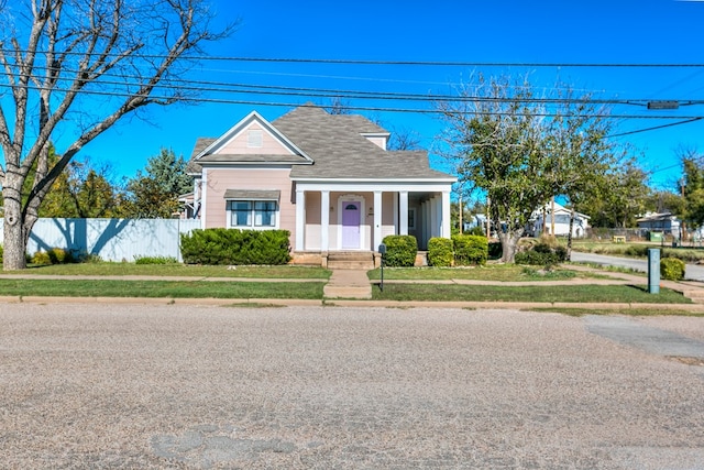 bungalow-style home with a front lawn