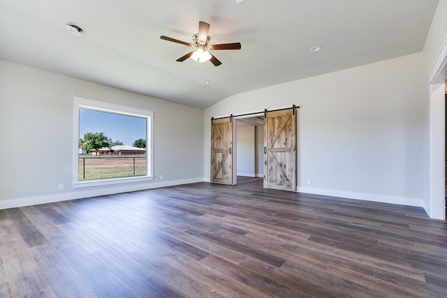 5001 Fm 2333, Bronte, TX 76933 - unfurnished bedroom featuring a barn door, dark wood-style flooring, baseboards, vaulted ceiling, and a ceiling fan