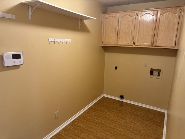 clothes washing area featuring hookup for a washing machine, cabinets, a textured ceiling, dark hardwood / wood-style flooring, and hookup for an electric dryer