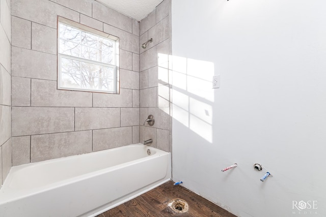 bathroom featuring hardwood / wood-style flooring and tiled shower / bath combo