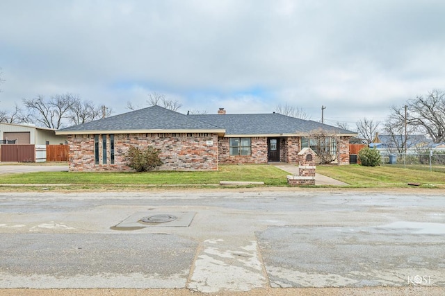 ranch-style home featuring a front lawn