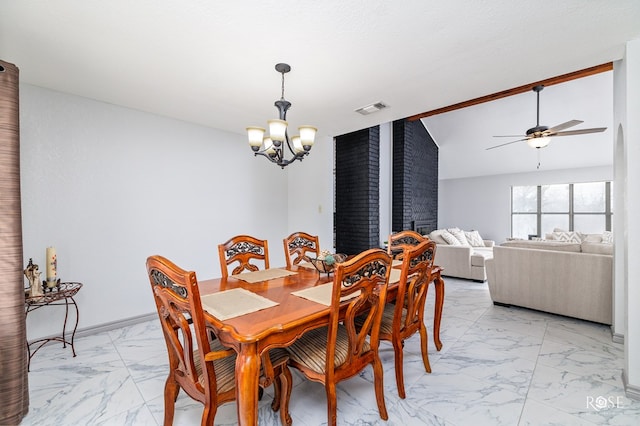 dining room featuring lofted ceiling and ceiling fan with notable chandelier