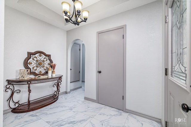 foyer featuring a chandelier