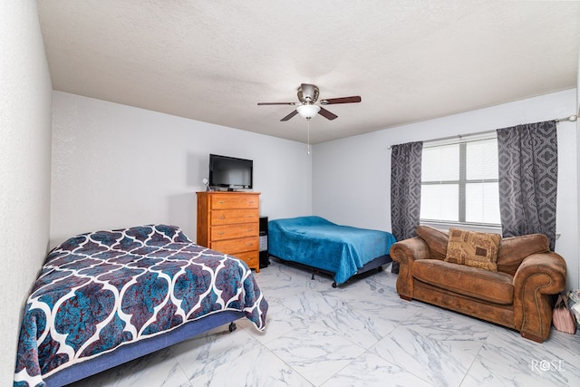 bedroom featuring a textured ceiling and ceiling fan