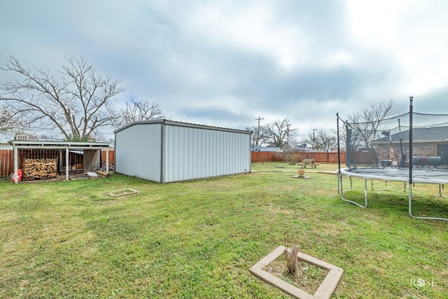 view of yard with a storage unit and a trampoline