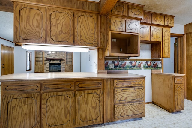 kitchen featuring a textured ceiling and kitchen peninsula