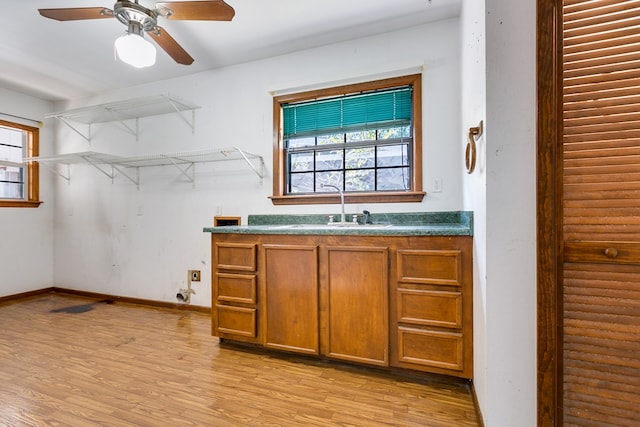 interior space featuring ceiling fan, sink, and light hardwood / wood-style floors