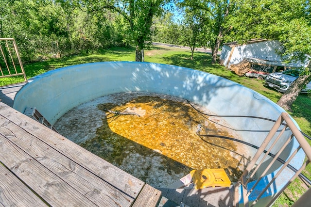 view of swimming pool with a lawn