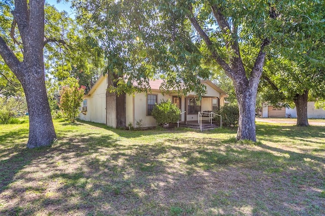 view of front of home with a front yard and covered porch