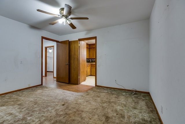 unfurnished bedroom with ceiling fan and light colored carpet