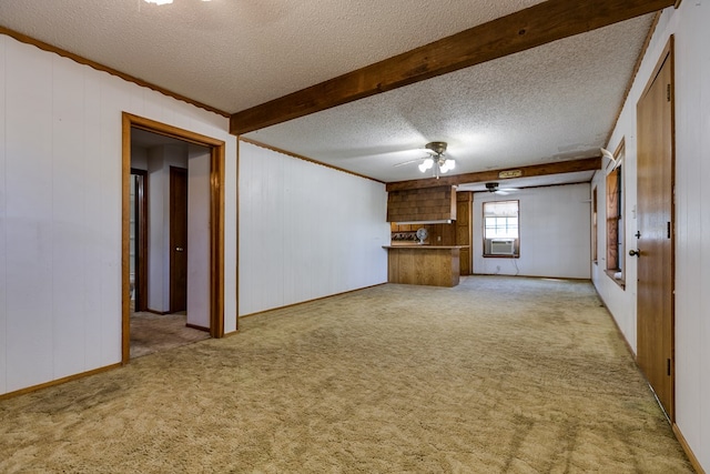 carpeted empty room featuring cooling unit, ceiling fan, a textured ceiling, and wood walls