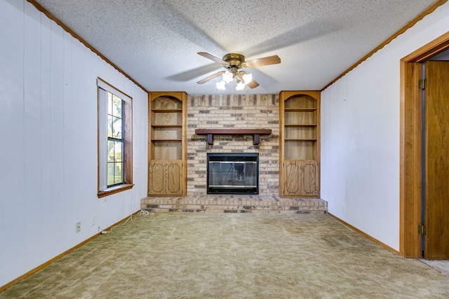 unfurnished living room featuring a textured ceiling, carpet floors, built in features, ceiling fan, and a fireplace