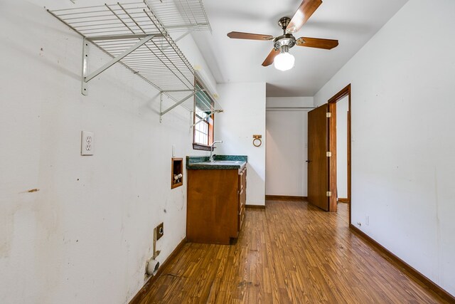 laundry area with sink, cabinets, ceiling fan, hookup for an electric dryer, and hardwood / wood-style floors