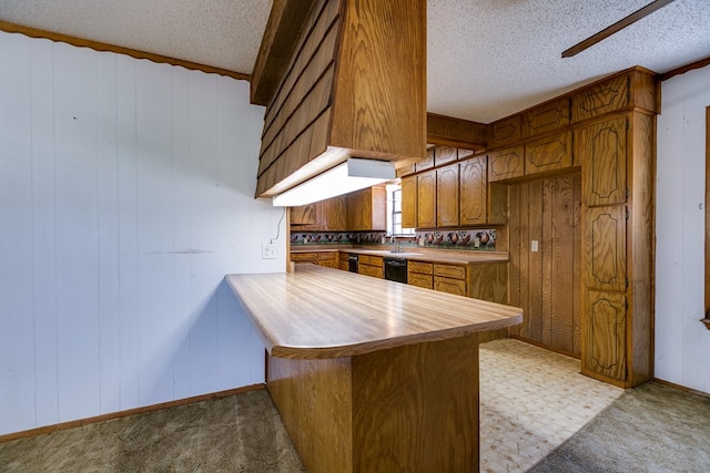 kitchen with black dishwasher, light colored carpet, a textured ceiling, and kitchen peninsula