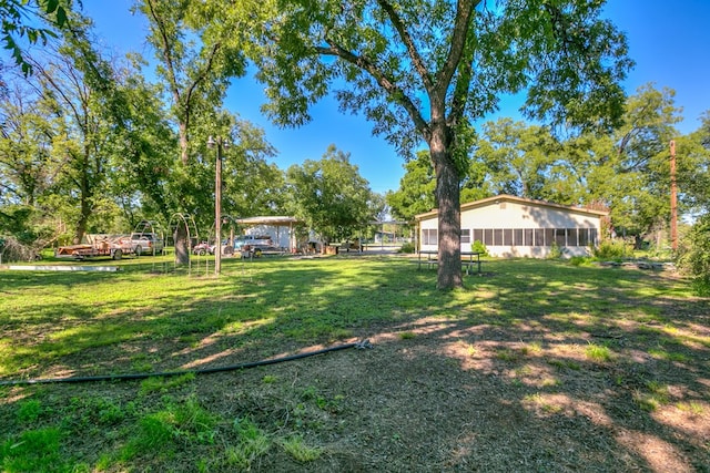 view of yard featuring a sunroom