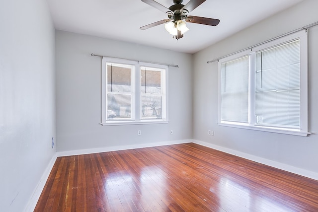 empty room with hardwood / wood-style flooring, baseboards, and ceiling fan