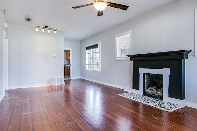 unfurnished living room with visible vents, baseboards, and wood-type flooring